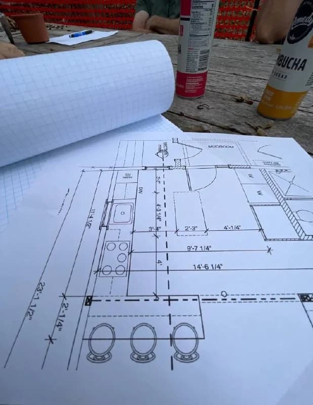 Cabinet design plans spread out on a table