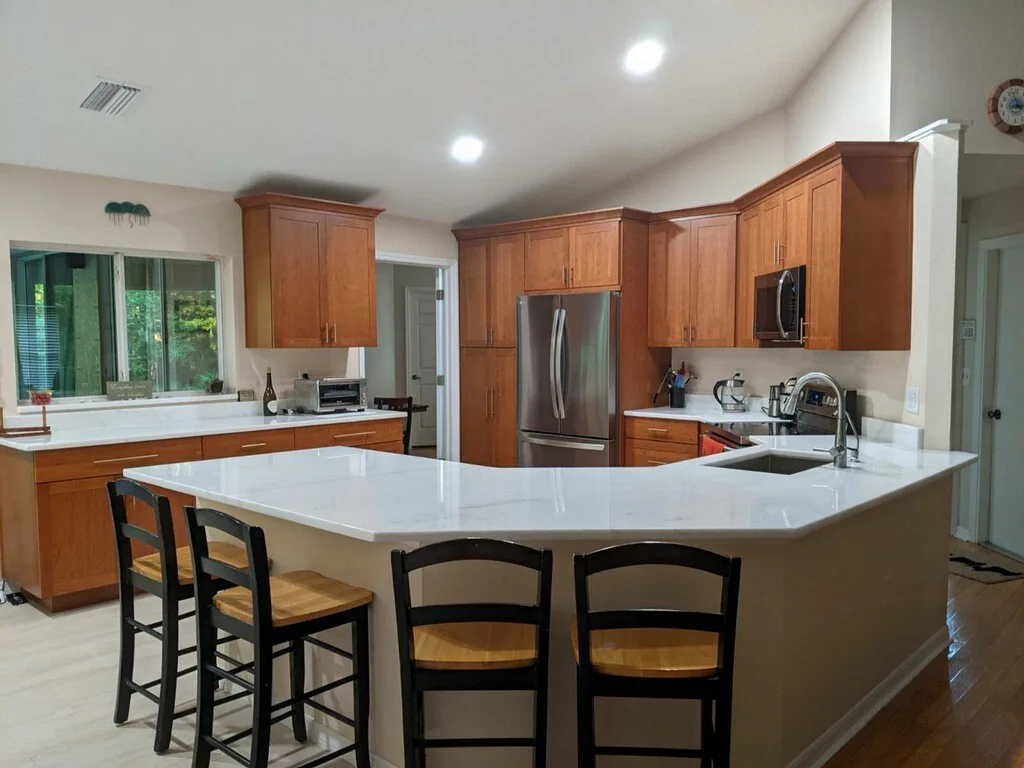 Portland ME kitchen — cherry shaker cabinets, white quartz island with bar seating