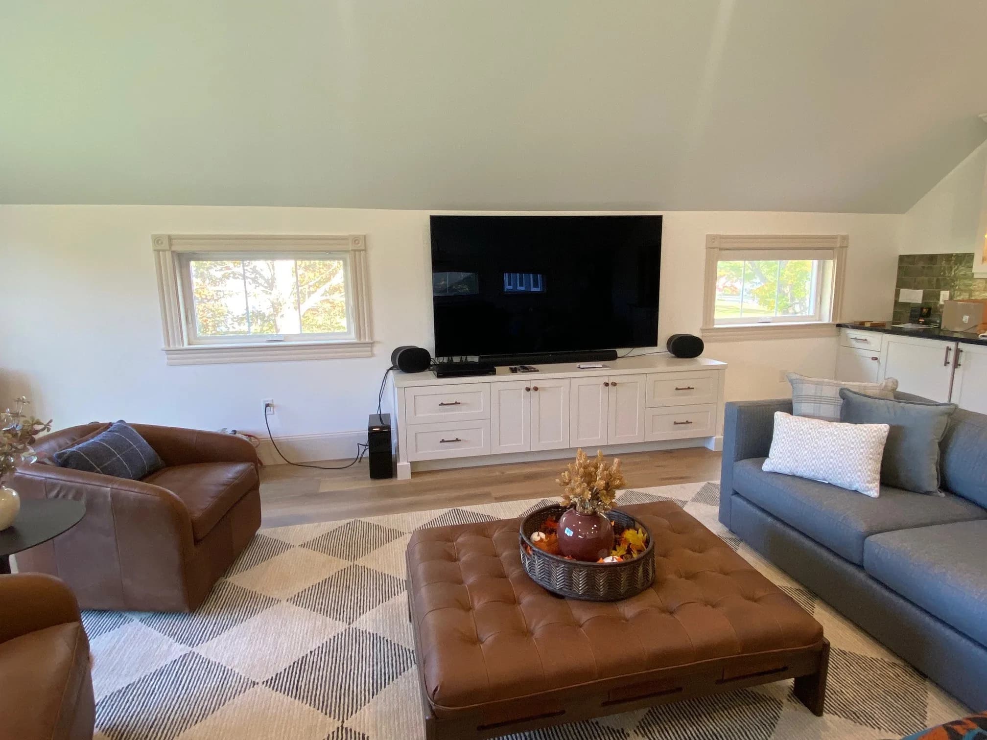 York ME media room — custom built-in TV console with white shaker cabinetry