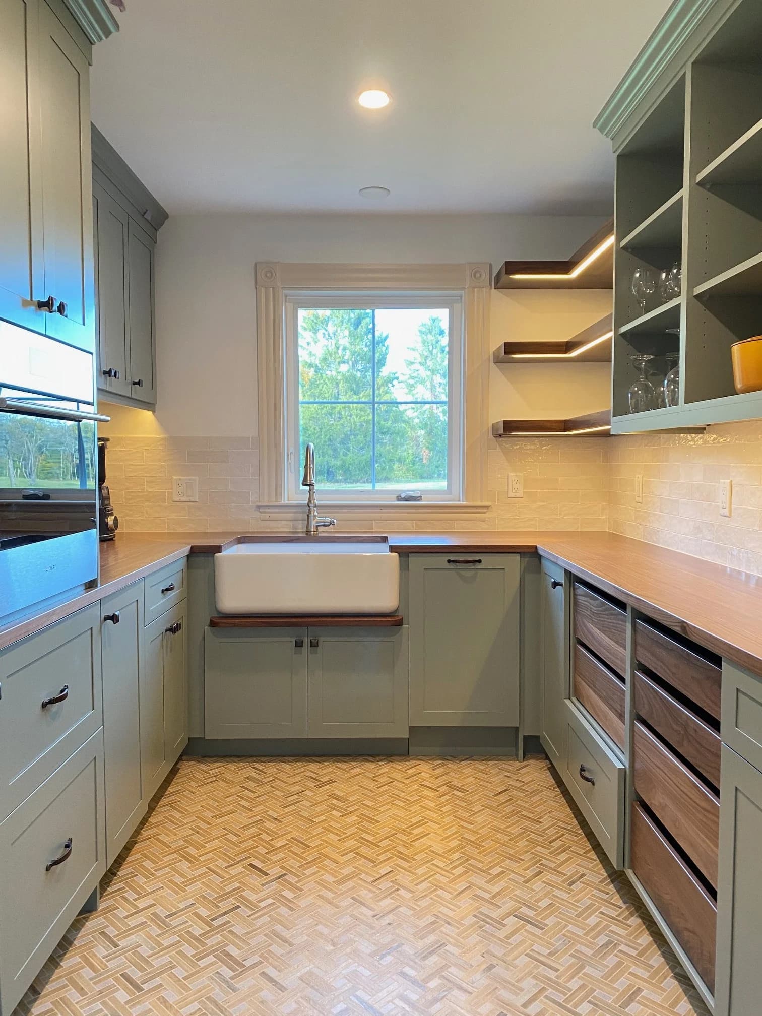 York ME pantry — sage green shaker cabinets, walnut butcher block, farmhouse sink